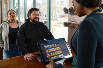 Barista serving a customer at a modern cafe counter