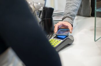 Customer paying by phone at a coffee shop