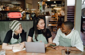 Cafe team reviewing the day together at a table