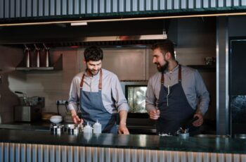 Two chefs working a restaurant kitchen line