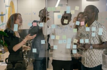 Team planning a rollout at a wall of sticky notes